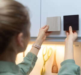 woman comparing cabinet material samples